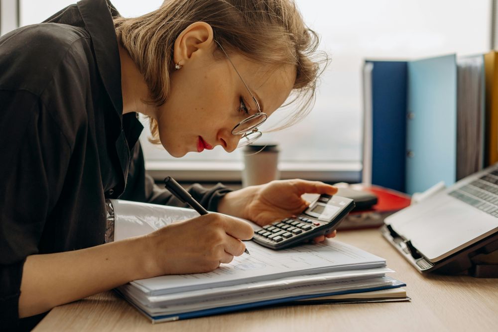 Eine Finanzamtmitarbeiterin prüft die Dokumente eines Unternehmens